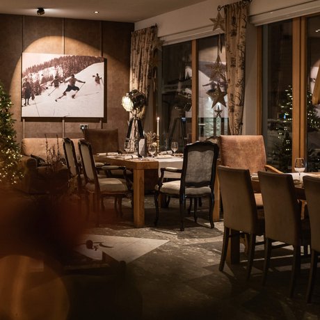 Ihre Unterkunft in St. Christoph am Arlberg: Bilder Gemütliches Restaurant mit festlicher Weihnachtsdekoration und gedeckten Tischen